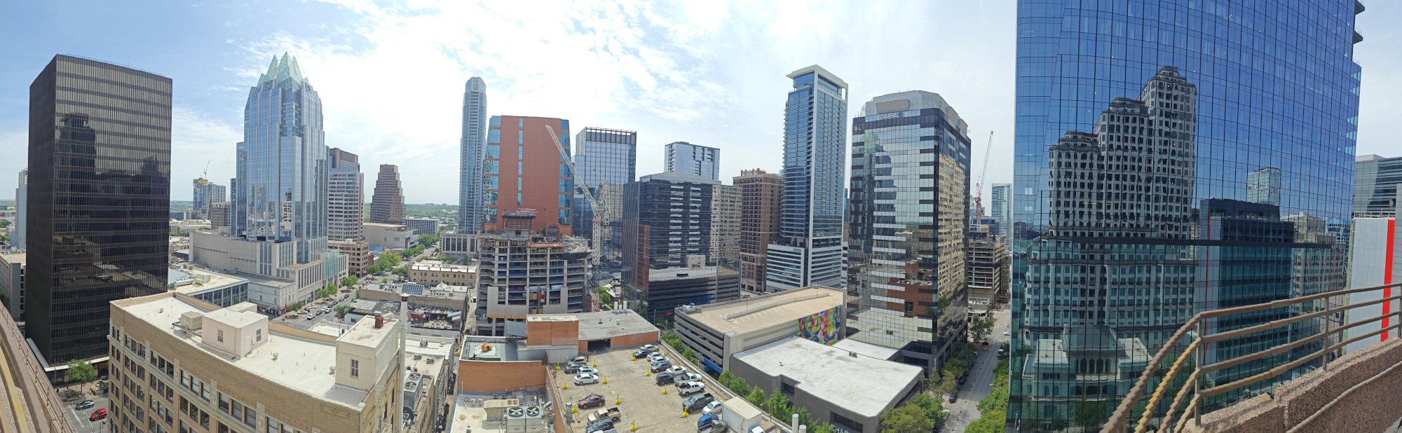 View of downtown Austin with construction cranes towering over the skyline, symbolizing the rapid urban growth and development happening in the city